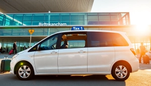 Providing a reliable taxi Nottingham to Birmingham Airport service with a professional vehicle in a bright setting.