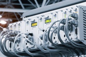 A row of computer cables with a clock on the left side.