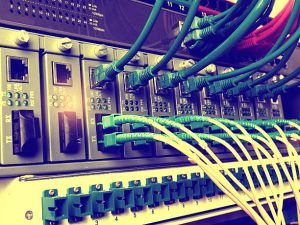 Fiber Optic cables and UTP Network cables connected hub ports.